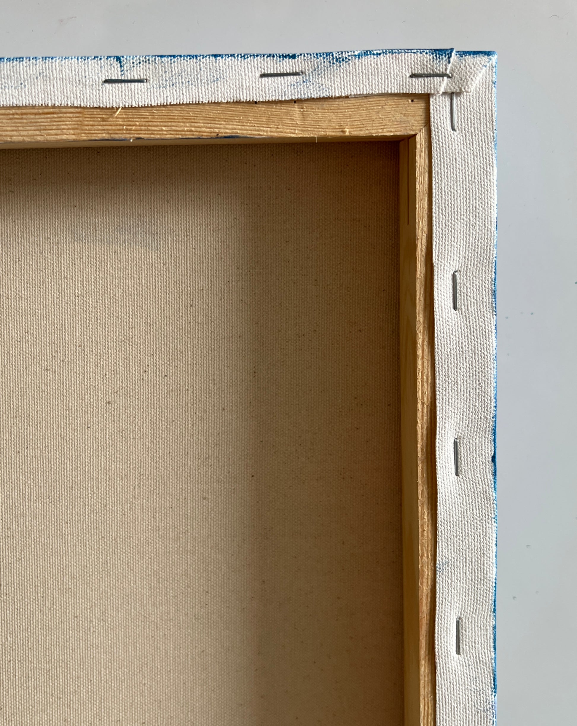 Close-up of a wooden picture frame with a gray background