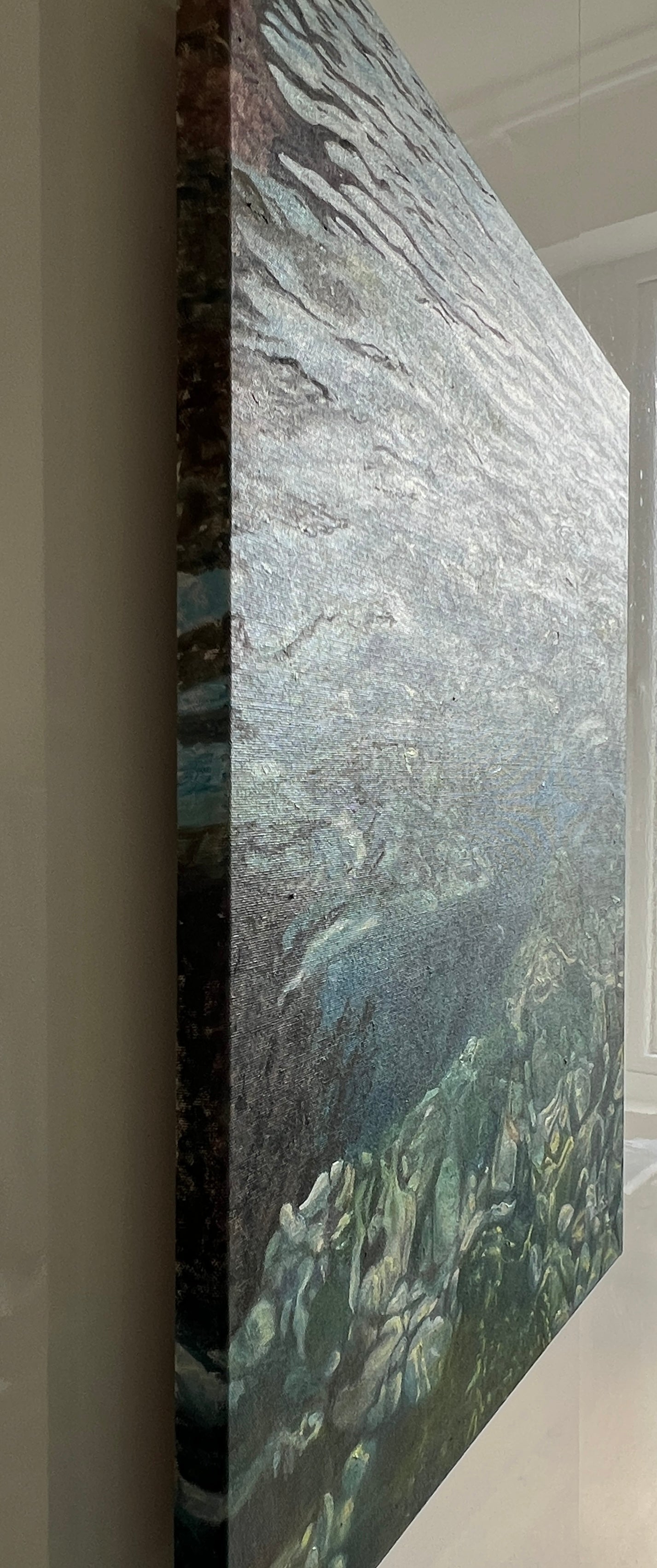 Close-up of a textured surface with a mix of gray, green, and brown colors.