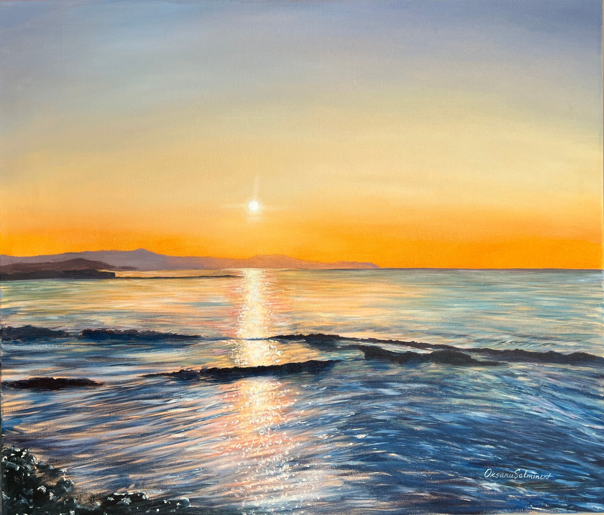 Sunset over a calm sea with a clear sky