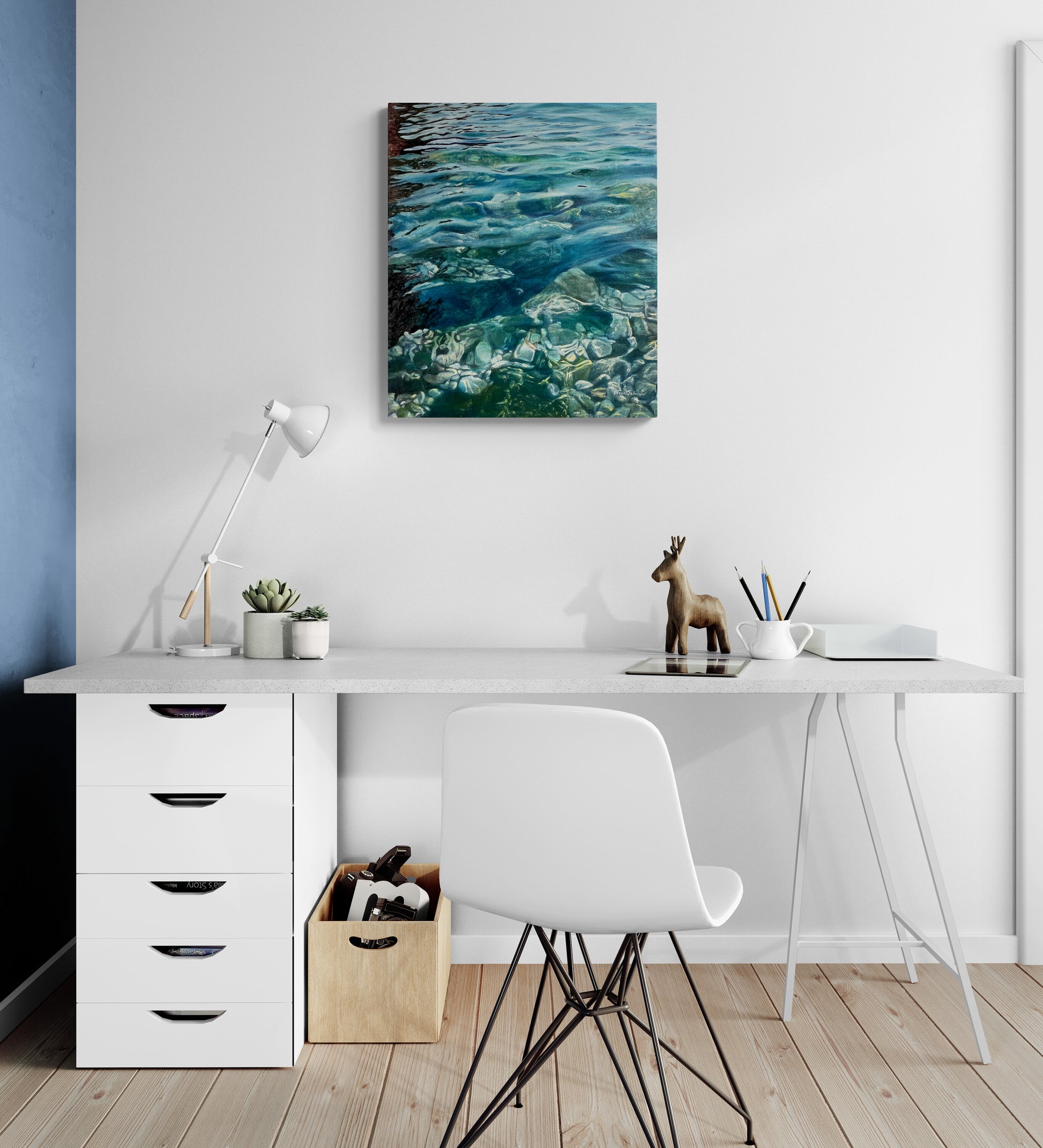 Modern home office with a desk, chair, lamp, and artwork on the wall.