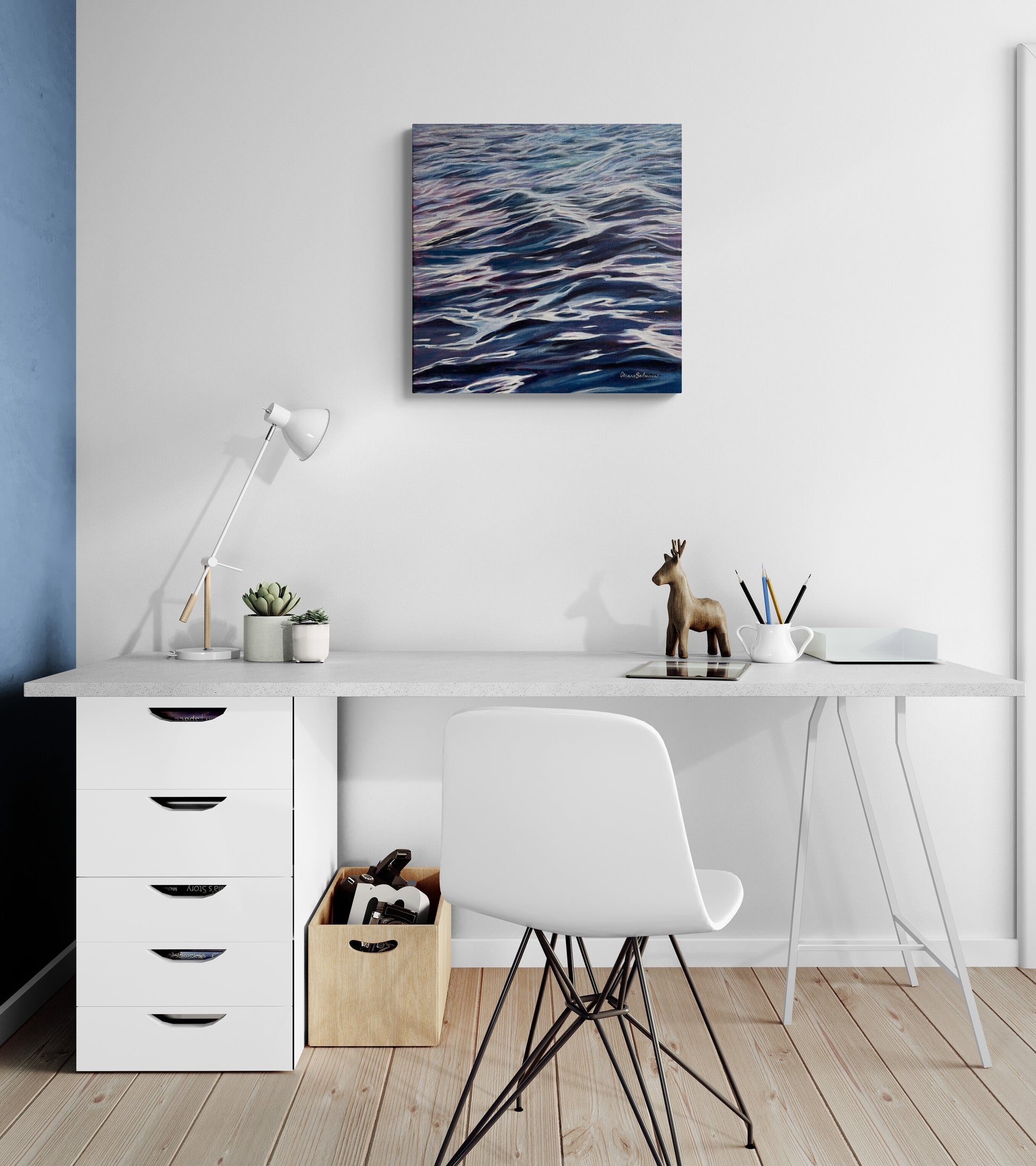 Modern home office with a desk, chair, and wall art