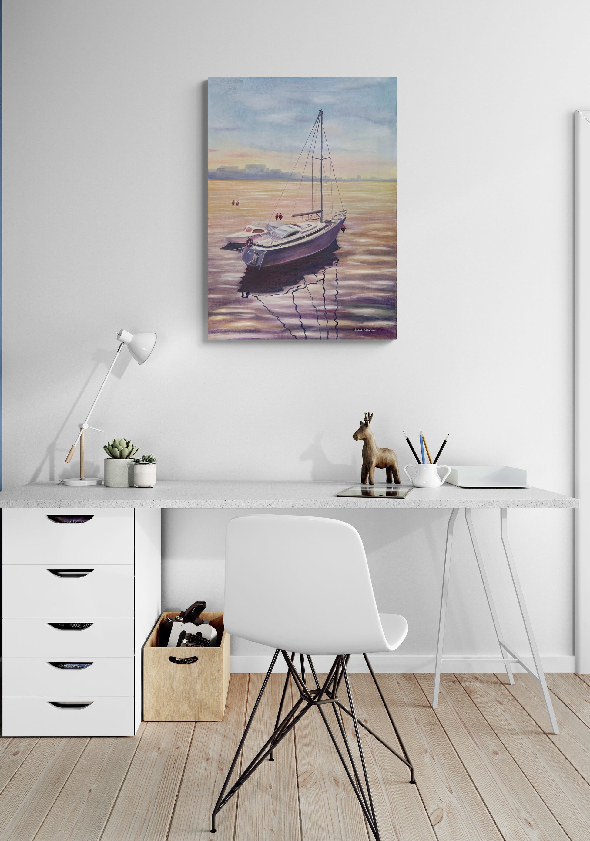 Home office with a desk, chair, and wall art of a boat on water.