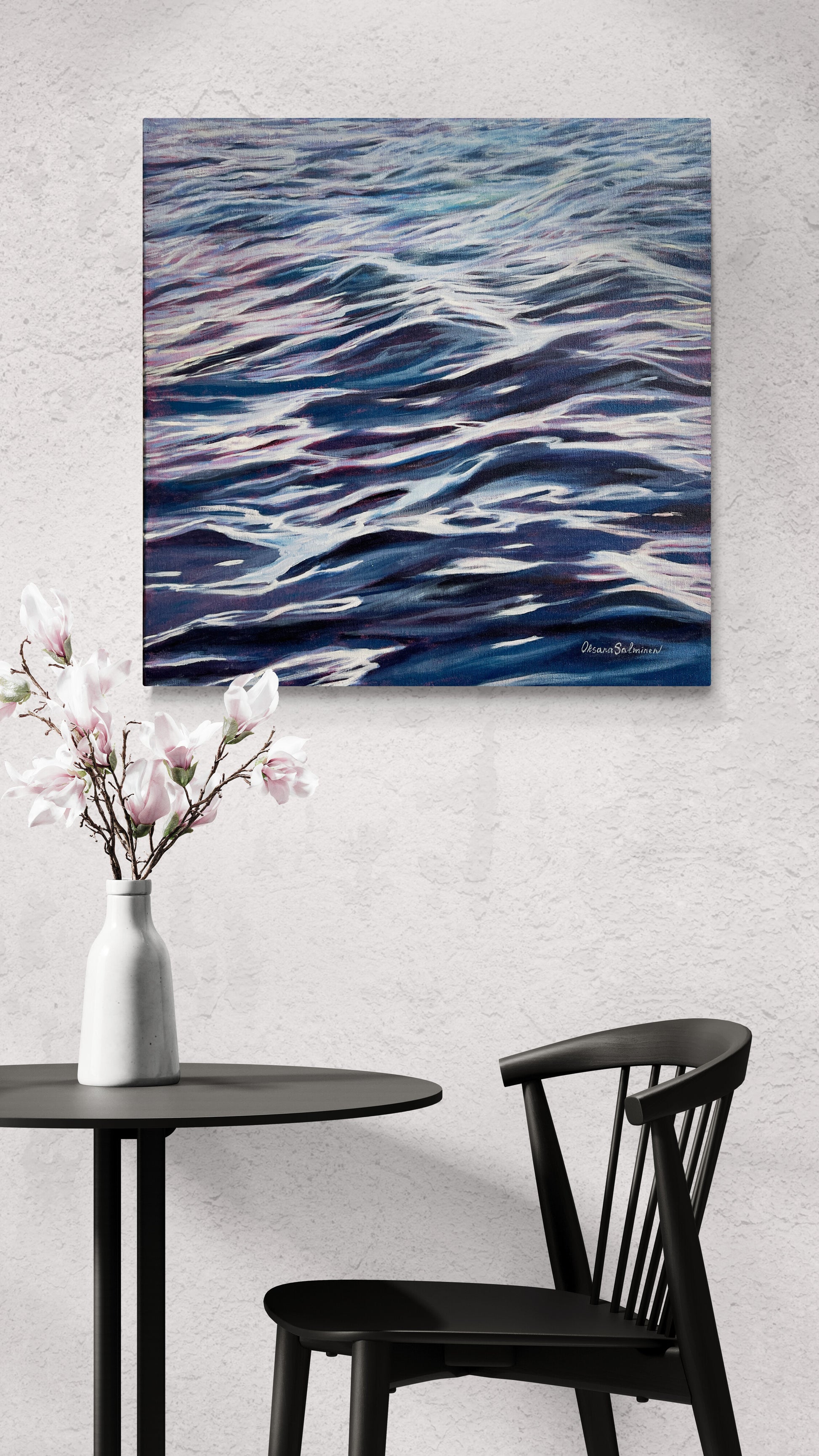 Abstract painting of wavy blue and purple patterns on a wall above a table with a vase and chair