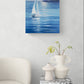 A vertical canvas print of a sailboat painting on a blue sea, styled in a modern living room setting above a side table with vases and a chair.