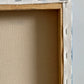 Close-up of a wooden picture frame with a gray background