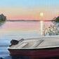 Boat on a lake at sunset with trees and calm water