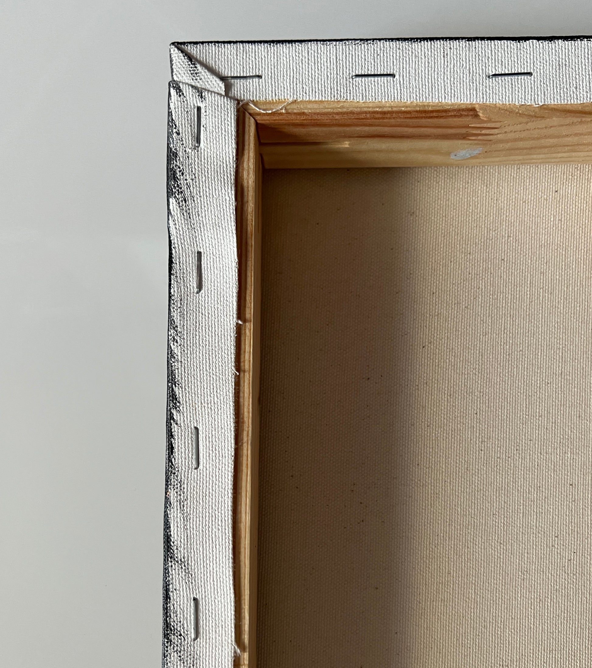 Close-up of a wooden picture frame with a gray interior.