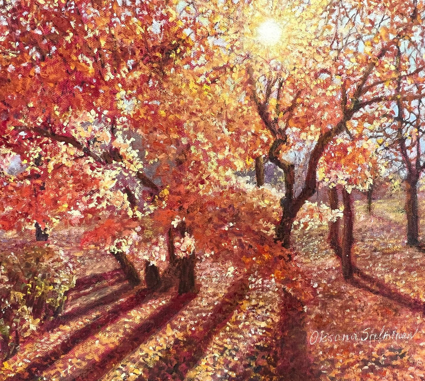 Painting of a path lined with trees in autumn with warm colors.
