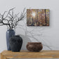 Decorative setup with vases and a forest painting on a wall.