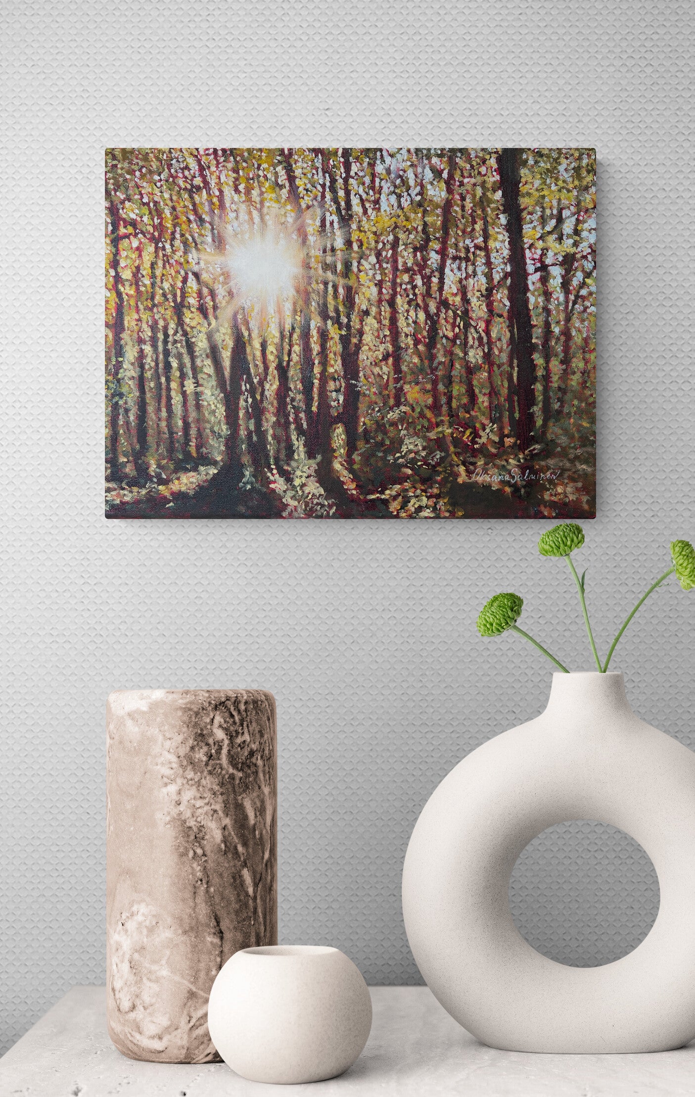 Forest scene painting on a wall above decorative vases.
