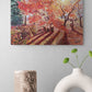 Oil painting of a colorful autumn landscape with trees and a path, displayed on a wall above decorative vases.