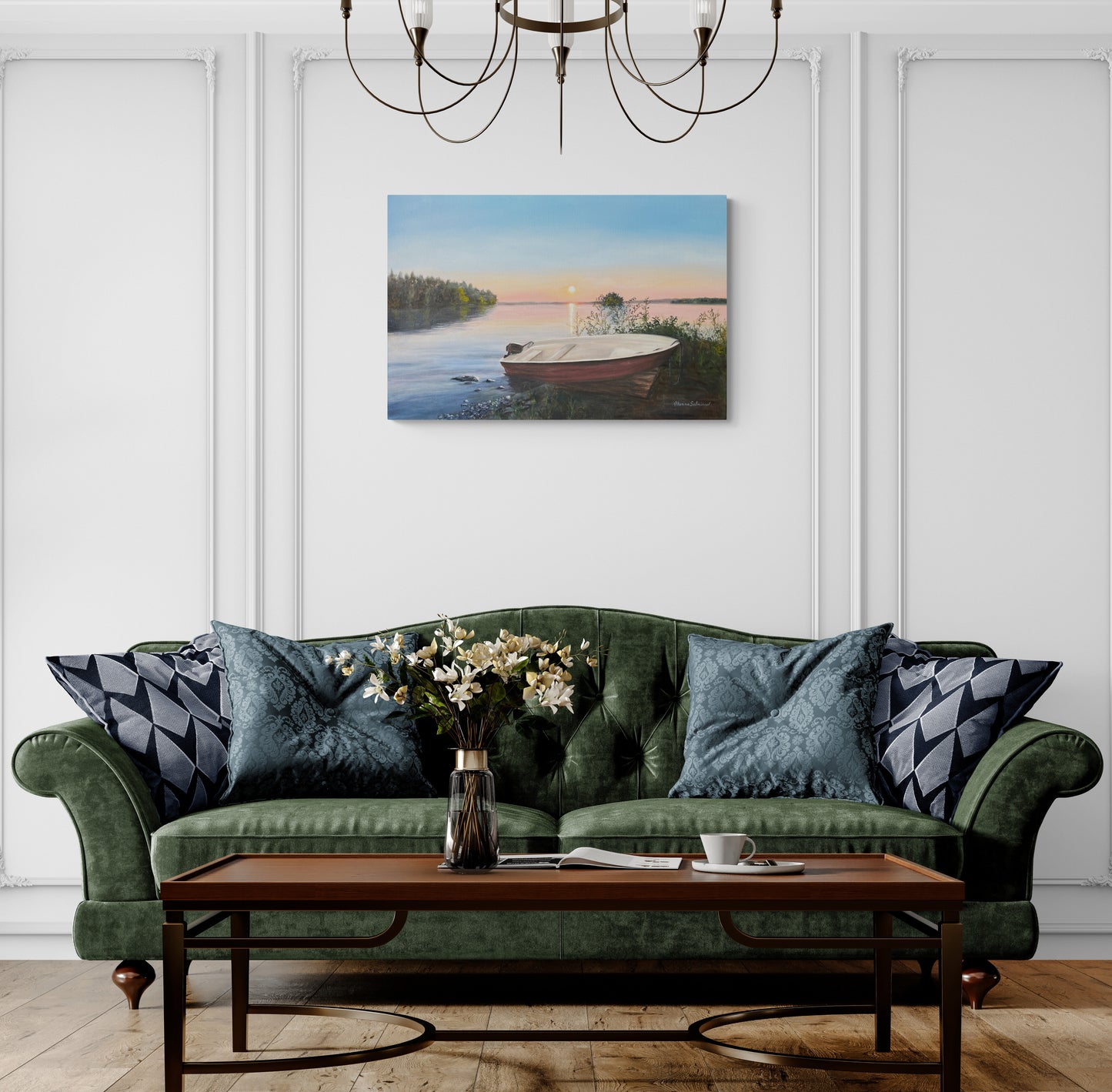 Living room with a green sofa, wooden coffee table, and wall art of a lake.