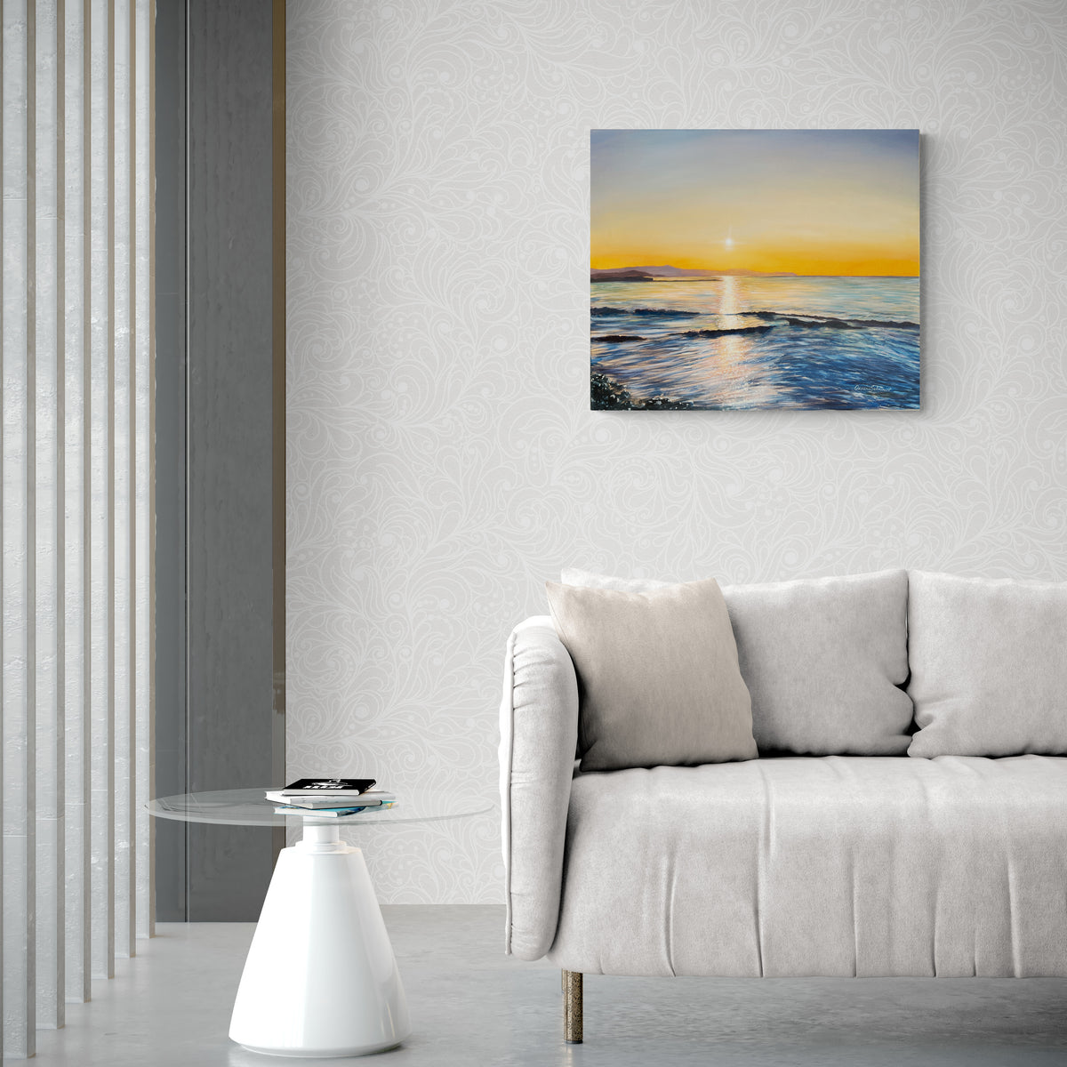 Original oil painting on canvas depicting a sunset over calm water, styled in a modern living room setting above a light gray sofa.
