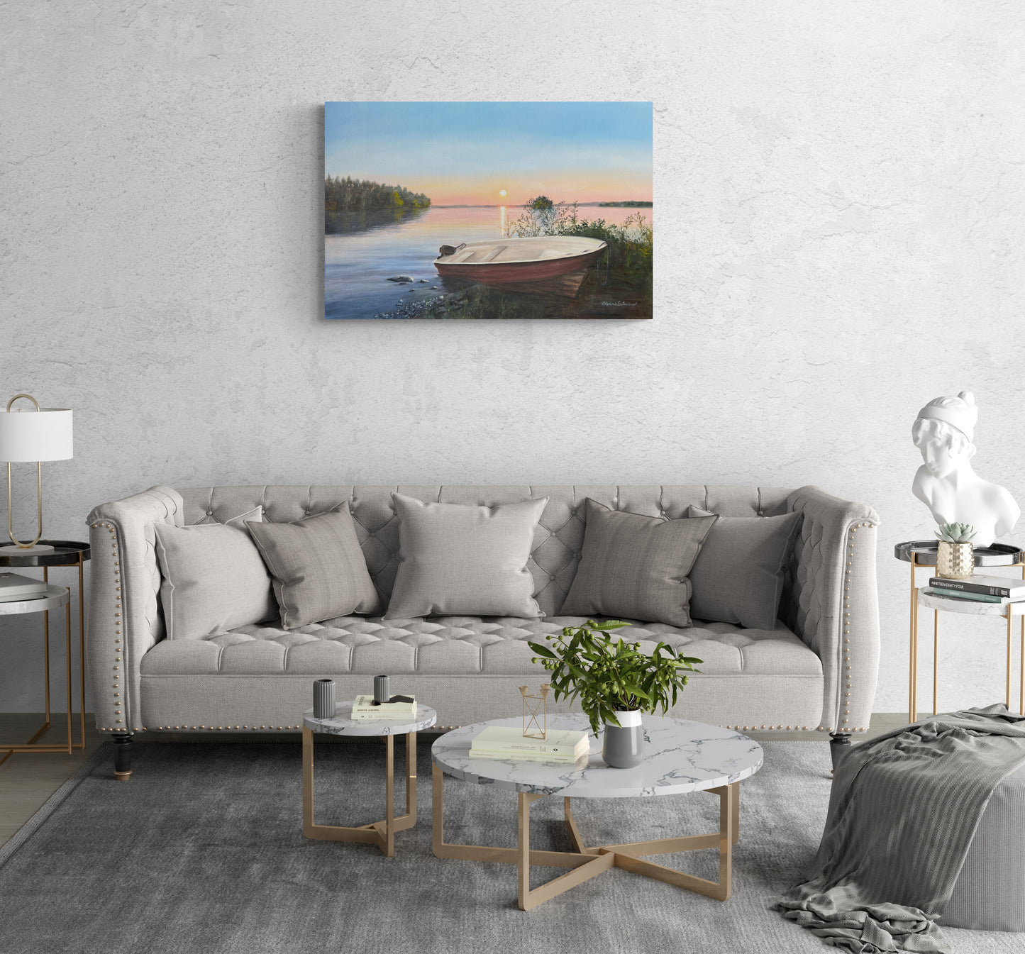 Living room with a gray sofa, marble coffee table, and wall art of a boat on water.