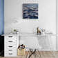 Modern home office with a desk, chair, and wall art