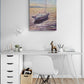 Home office with a desk, chair, and wall art of a boat on water.