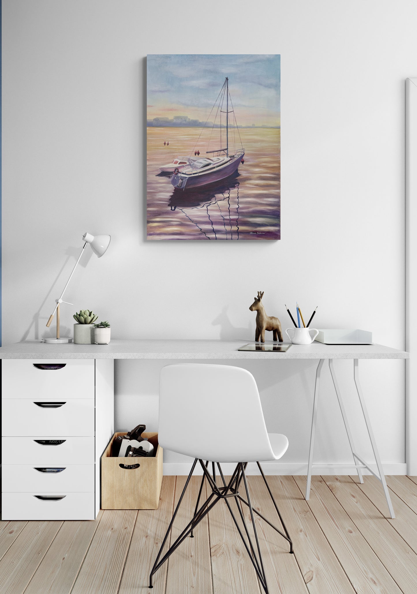 Home office with a desk, chair, and wall art of a boat on water.