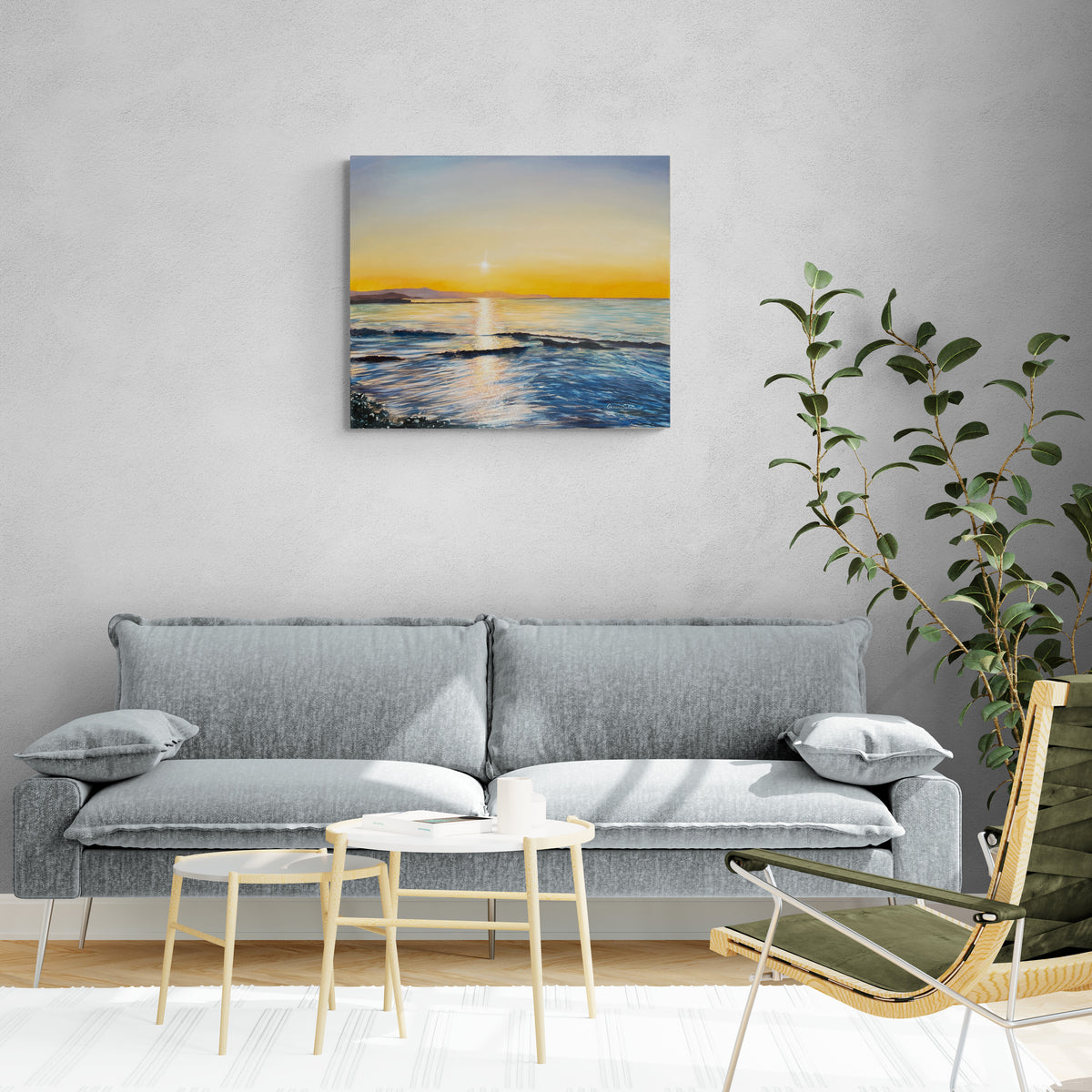 Original oil painting on canvas depicting a sunset over water, styled in a modern living room setting above a gray fabric sofa.